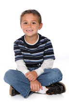 young boy sitting crossed leg on the floor