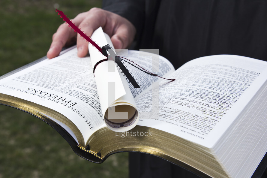 diploma on a Bible