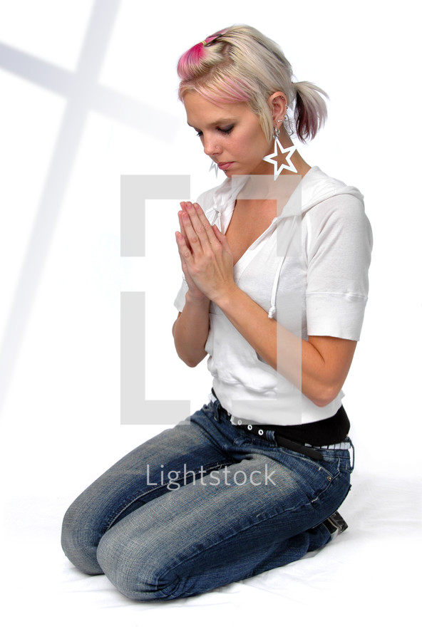 teen girl kneeling in prayer 