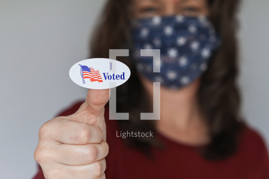 woman with an I voted sticker wearing a face mask 