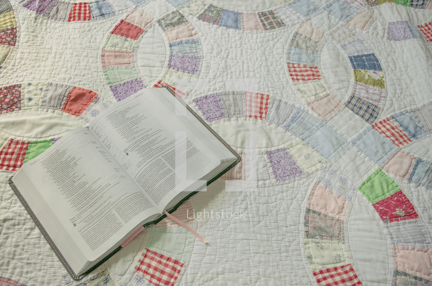 opened Bible on a quilt 