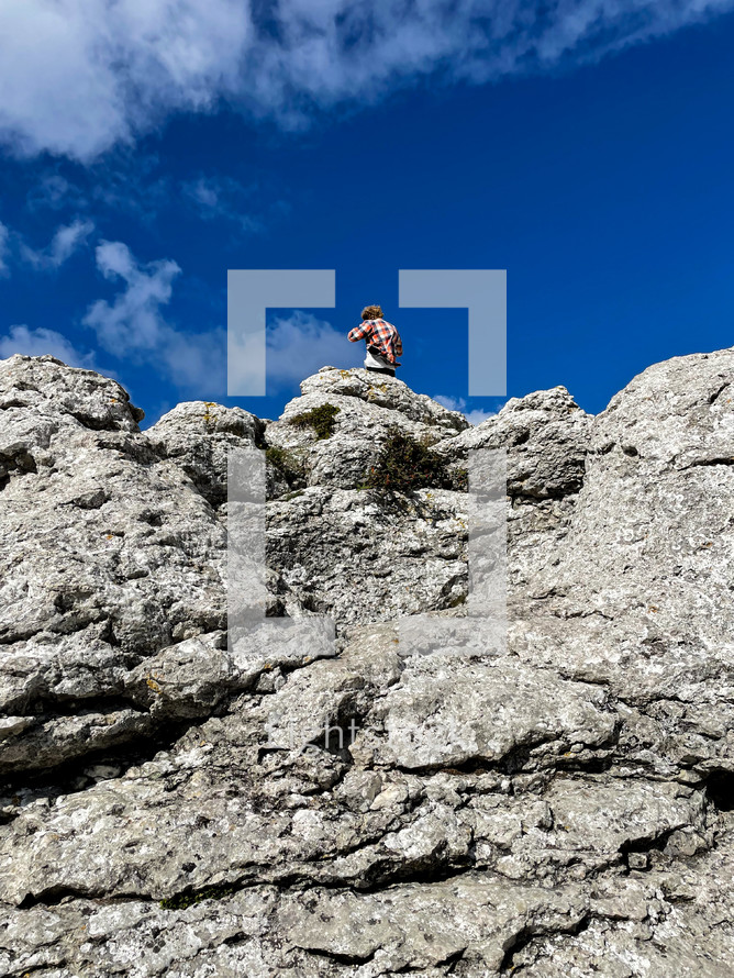 a man standing on a rocky cliff 