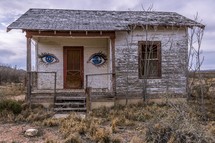 eyes painted on an abandoned house 