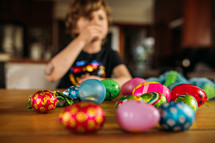 Child eating candy out of Easter eggs 