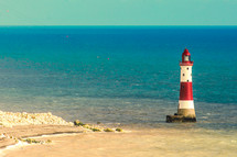 A lighthouse in a blue ocean.