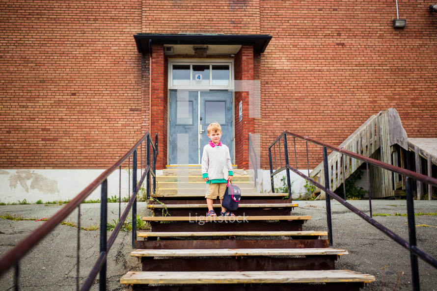 child in front of a school 