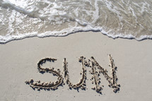 word sun written on the beach 