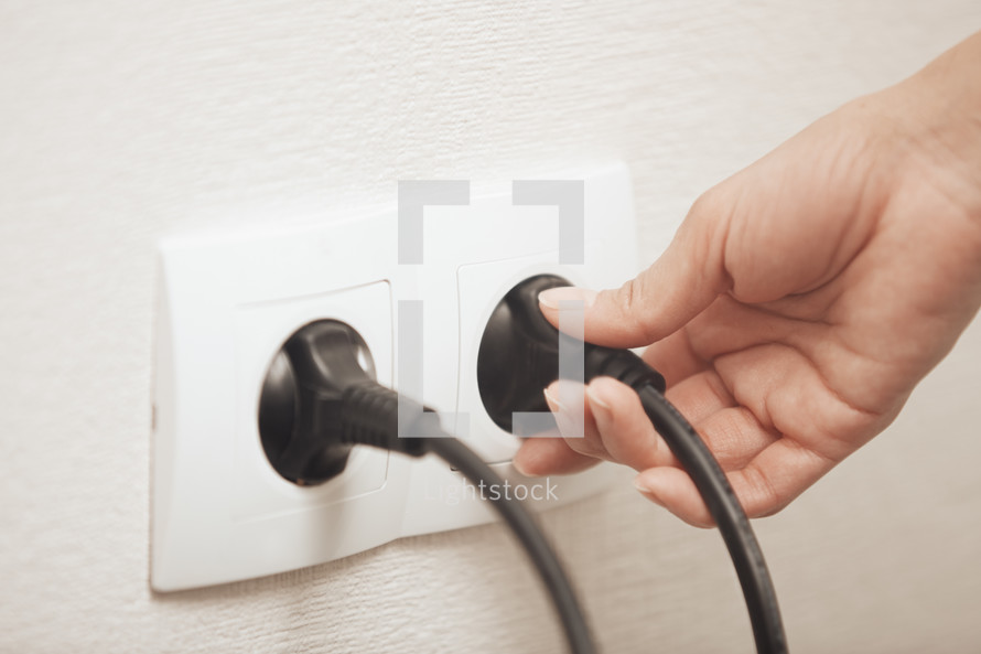 plugging in an electric cord 