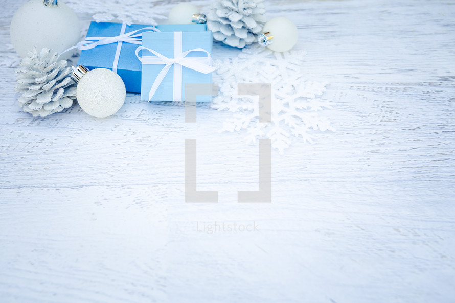 blue gift boxes and white pine cones in a corner 