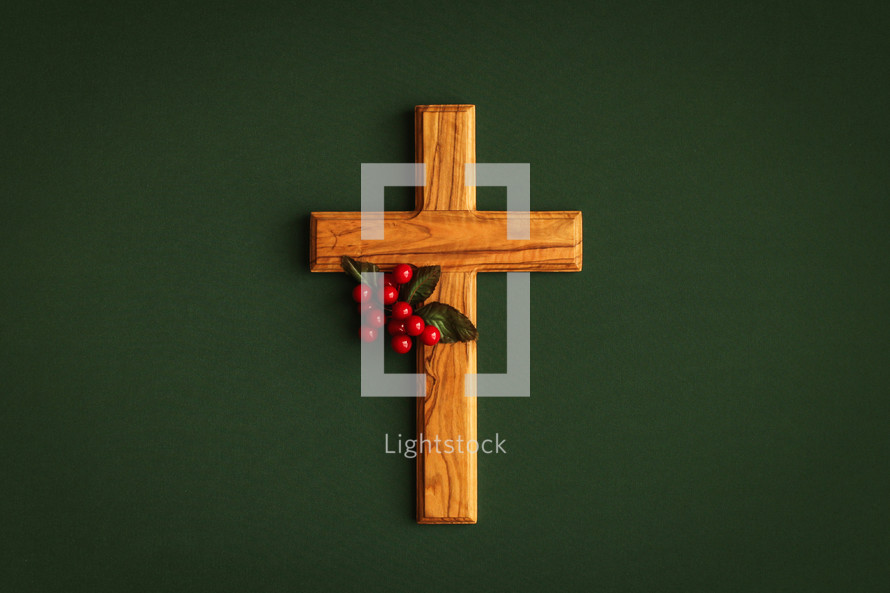 wooden cross with red berries 