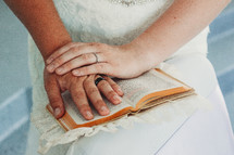 bride and groom with their hands on a Bible 