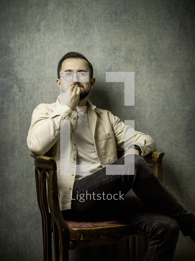 Portrait of a man thinking in a chair