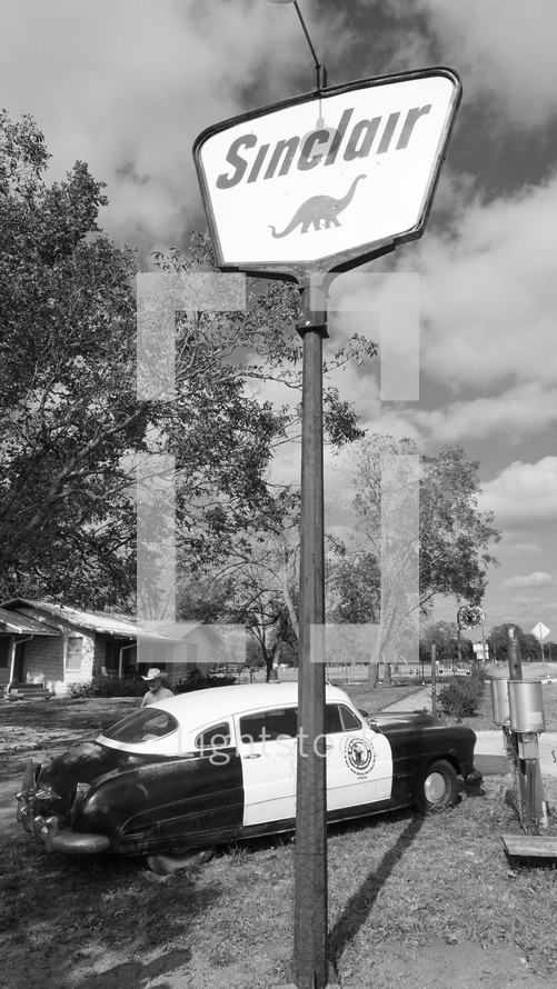 old Sinclair gas station sign and vintage car 