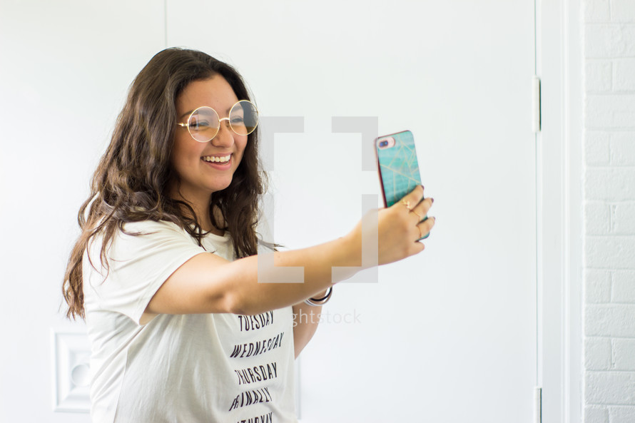 a young woman taking a selfie 