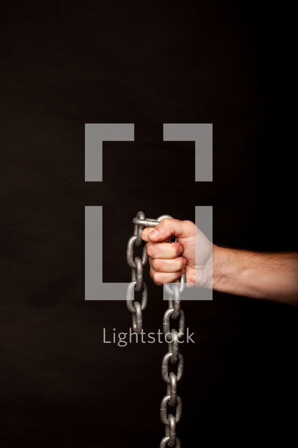 hand gripping a chain 