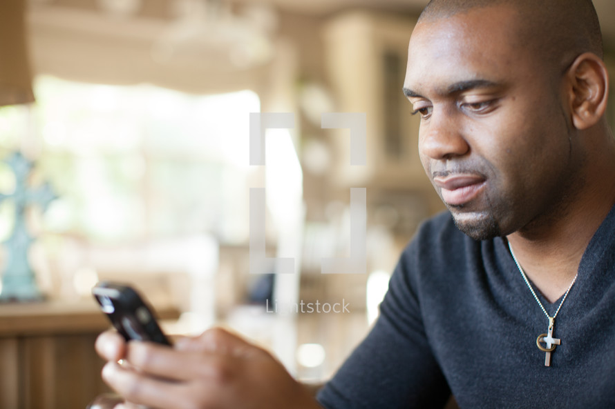 African- American man texting on a cellphone 