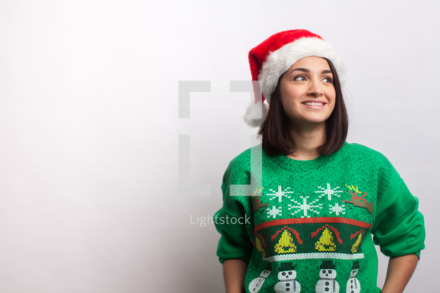 woman in an ugly Christmas sweater and santa hat 