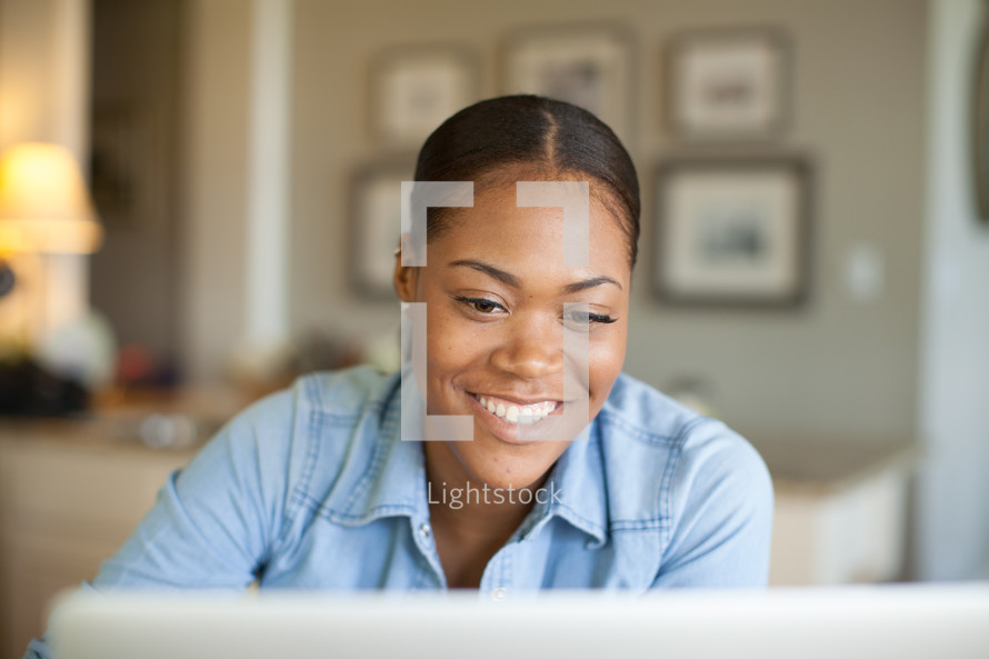 African-american woman looking at a computer screen 