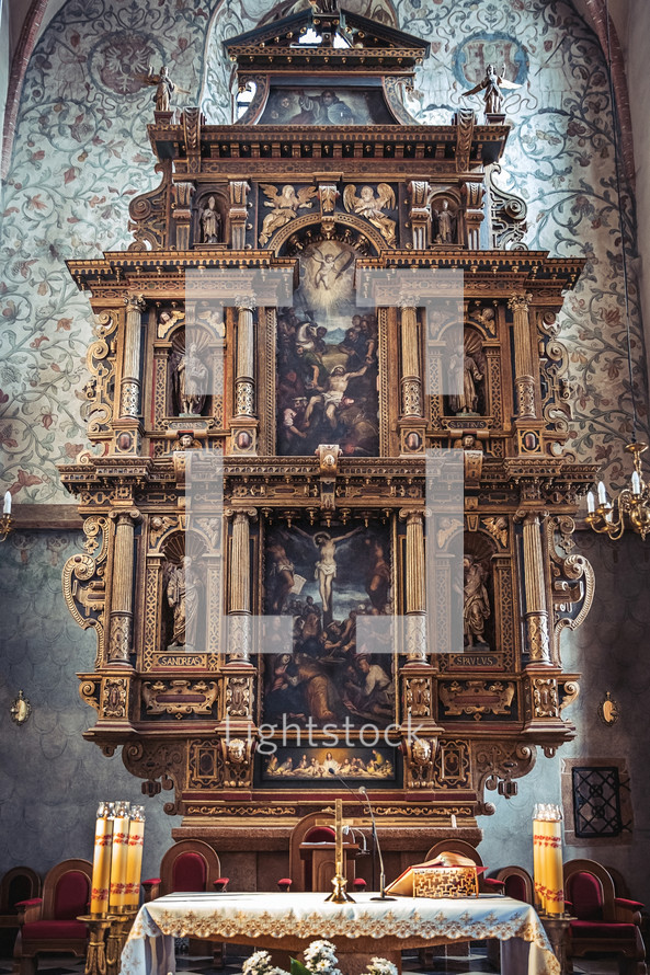 A medieval high altar with sculptures and paintings in basilica in Poland.