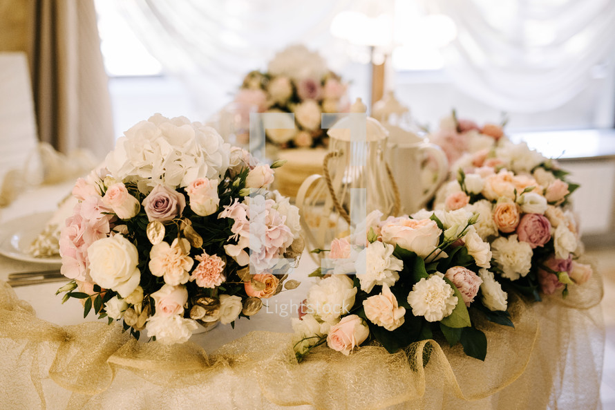 flower bouquets on a table at a wedding reception 