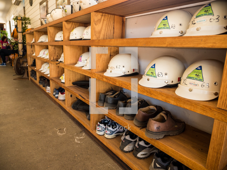 construction helmets and boots on a shelves 