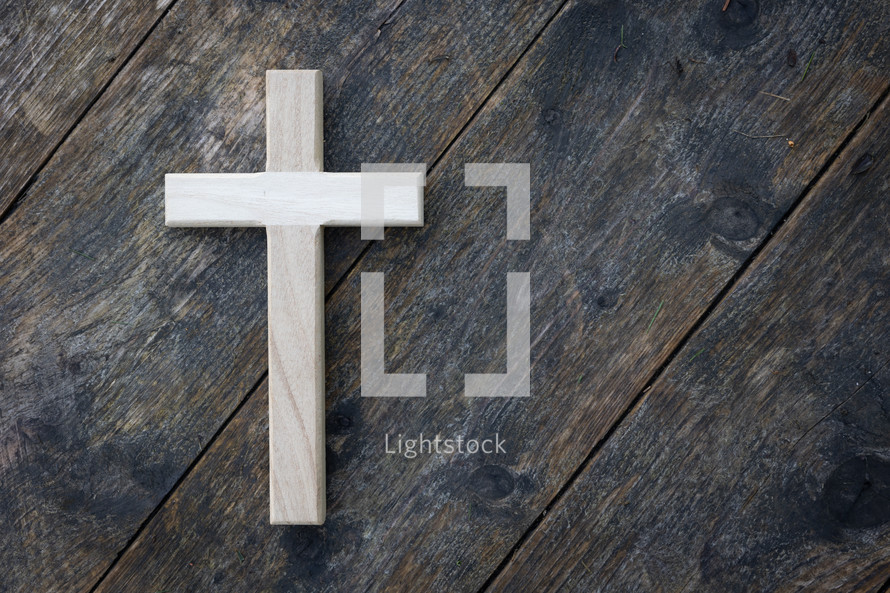 cross on a rustic wood background 