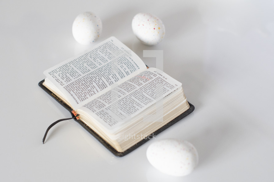 candy eggs and pages of a Bible 