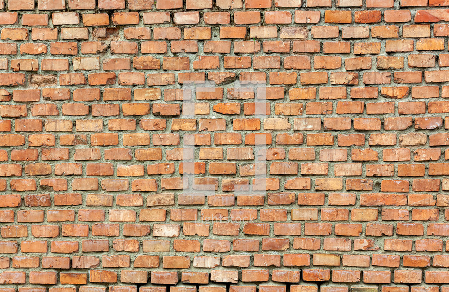 Full frame detailed background of a weathered red brick wall, ideal for texture and patterns