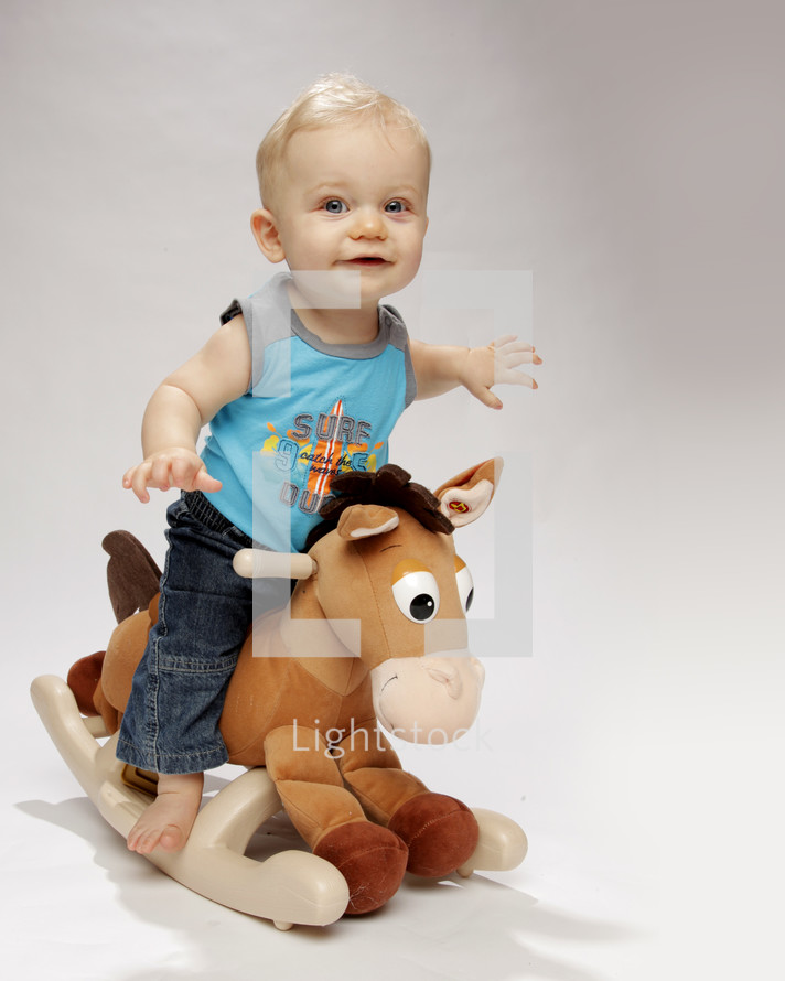 toddler boy on a rocking horse 