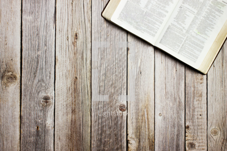 open Bible on a wooden background 