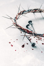 Crown of thorns with blood dripping, nails on stone. Christian concept of Jesus Christ suffering, passion. Good Friday, Easter holiday. Copy space. Crucifixion, resurrection, gospel, salvation