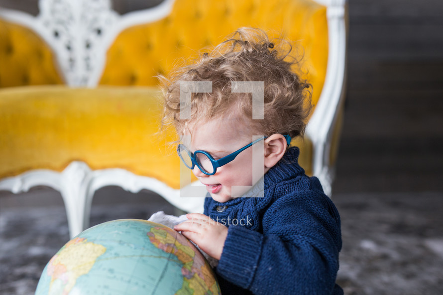 a child playing with a globe 