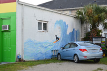 street art of a dog surfing a wave 
