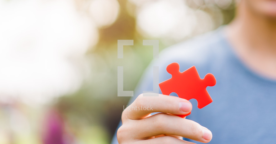a person holding a puzzle piece 