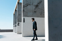 a man standing in front of numbered walls 