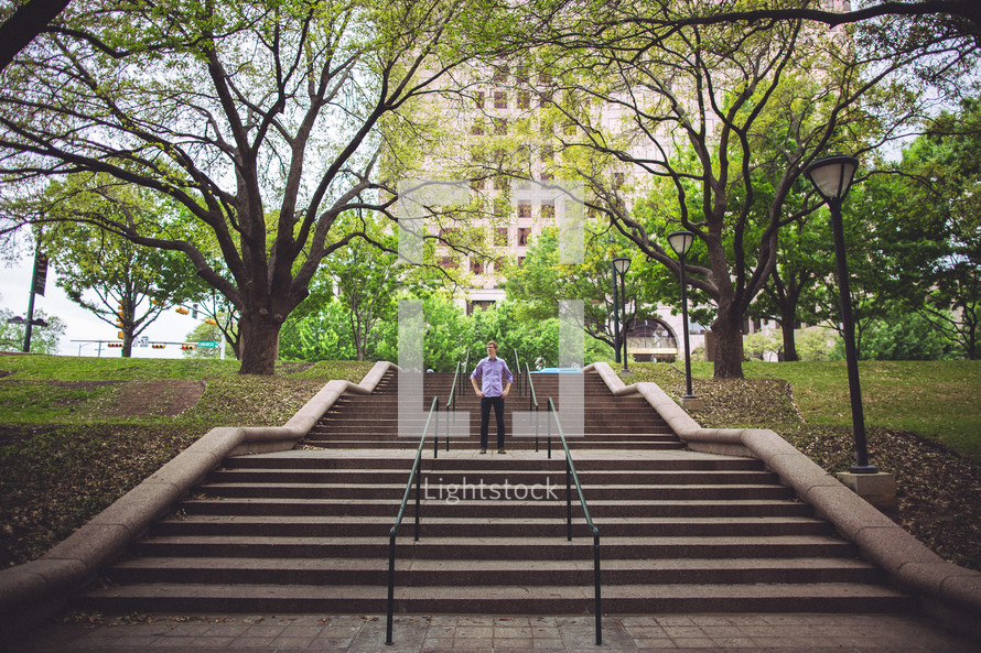 man standing on outdoor stairs 
