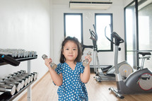 child lifting weights at the gym