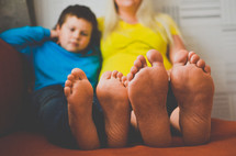 a mother and son's bare feet 