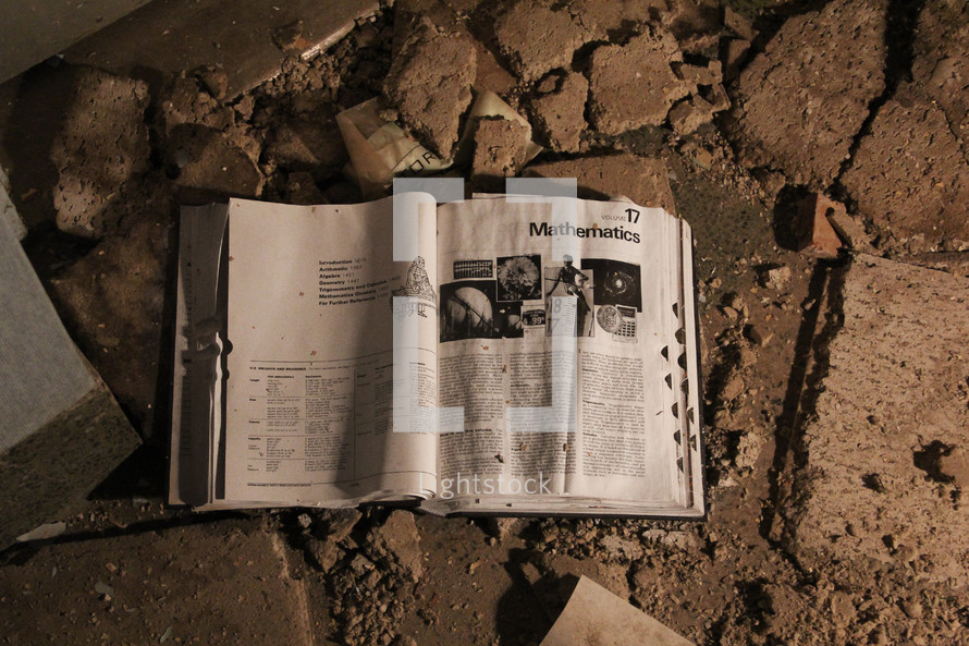 an open mathematics book in rubble 