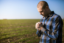 man in prayer in a field