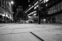 empty sidewalk in a city at night 