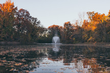 a fountain in a fall lake 