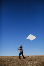 Man carrying a white surrender flag
