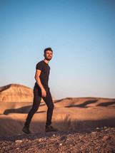 a man walking in a desert 