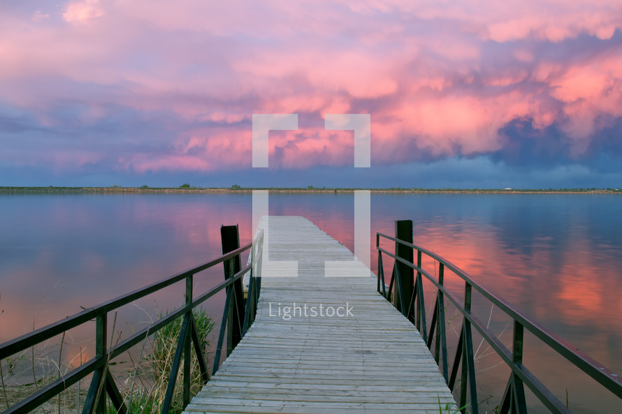 lake dock and pink clouds 