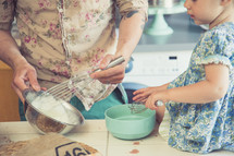 father and daughter baking in a kitchen 