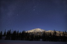 stars over an icy mountain peak 