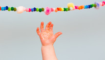 a sticky infant hand reaching for a banner 