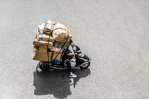man with boxes on a scooter 