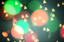 colored bokeh Christmas lights and Christmas trees 